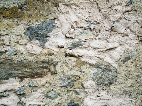 Format-filling view of a rough wall made of different quarry stones.
