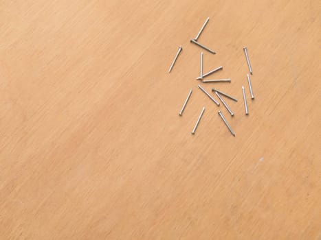 Carpentry material, several new nails on wooden background board