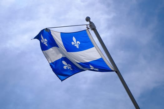 Quebec Flag pole on blue sky national st-jean banner