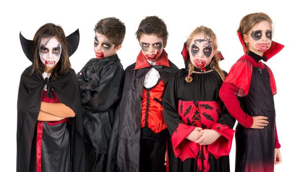 Group of kids with face-paint and Halloween vampire costumes