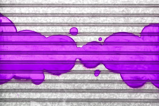 Purple bubbles painted with spray paint on a roller shutter.