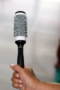 hand holding hairbrush tool