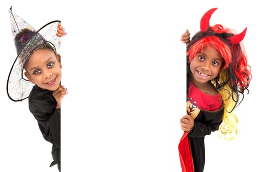 Girls with face-paint and Halloween costumes over a white background