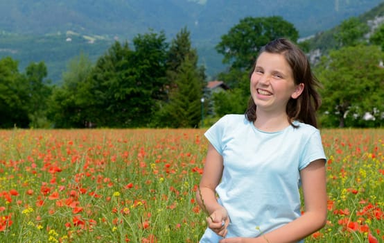a young teenage girl in poppy field