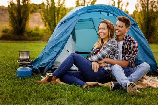 Shot of a happy couple camping on the nature
