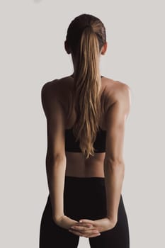 Shot of a young woman doing stretching exercises