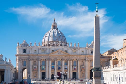 VATICAN CITY, VATICAN - OCTOBER 16, 2016: tourists at the famous saint peter's square in front of the Basilica di san pietro