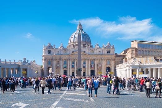 VATICAN CITY, VATICAN - OCTOBER 16, 2016: tourists at the famous saint peter's square in front of the Basilica di san pietro