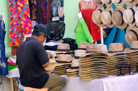OAXACA, MEXICO, MARCH 4: Man sells hats and clothes on the street in Oaxaca, Mexico on March 4, 2017