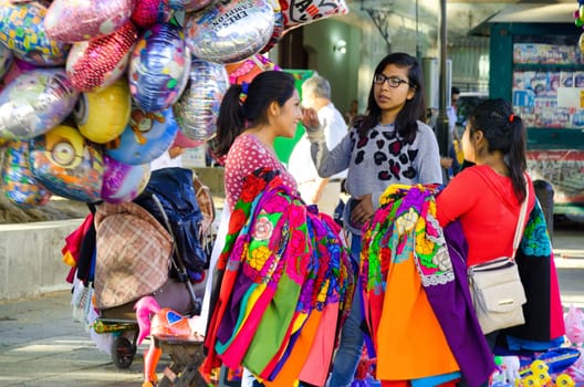 OAXACA, MEXICO - MARCH 4: Girls selling traditional clothes on the street in Oaxaca, Mexico on March 4, 2017