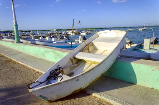 Old boat in waterfront in Rio Lagartos, Mexico