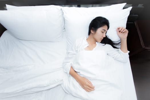 Happy young beauty women sleeping and smile on bed in the morning