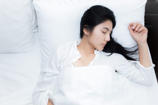 Happy young beauty women sleeping and smile on bed in the morning