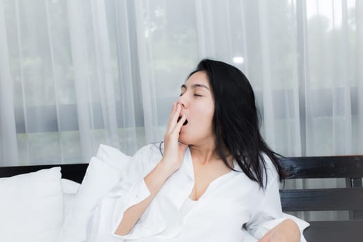 Happy young beauty women sleeping and smile on bed in the morning