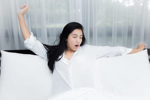 Happy young beauty women sleeping and smile on bed in the morning