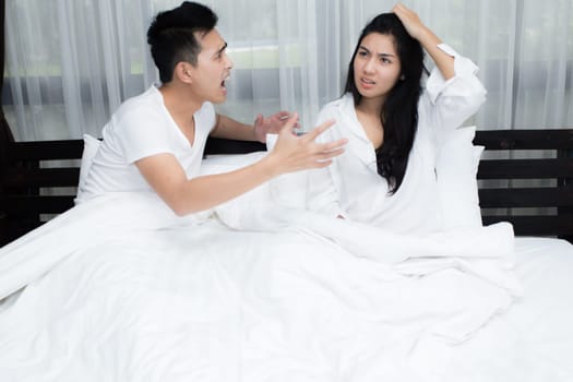 Young loving couple on the bed in the morning