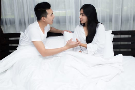 Young loving couple on the bed in the morning