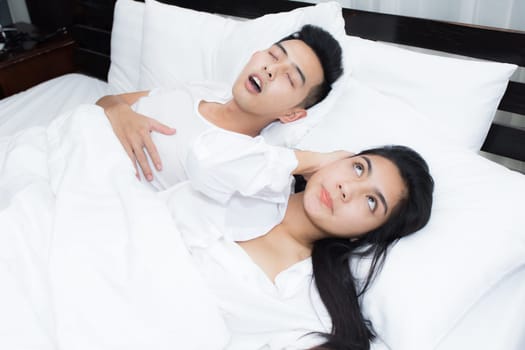 Young loving couple on the bed in the morning