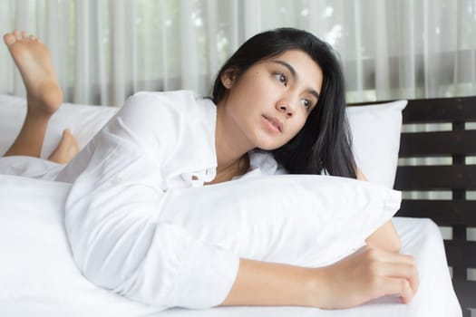 Happy young beauty women sleeping and smile on bed in the morning