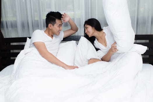 Young loving couple on the bed in the morning