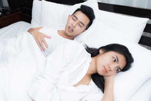 Young loving couple on the bed in the morning