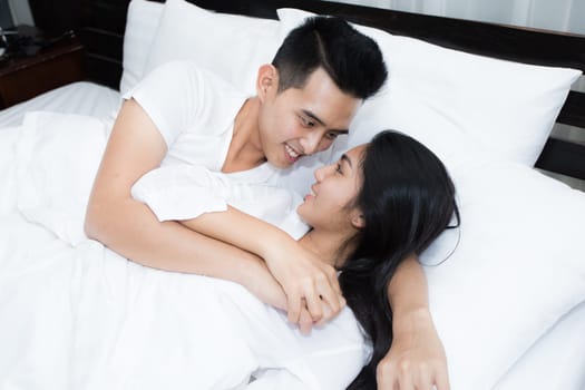 Unhappy couple having problems at bedroom in the morning