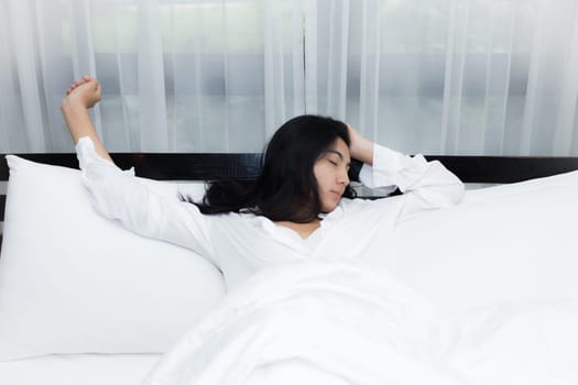 Happy young beauty women sleeping and smile on bed in the morning