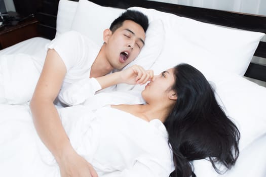 Young loving couple on the bed in the morning