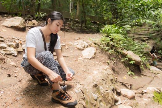 Young asian woman near public board with map, routes and locations