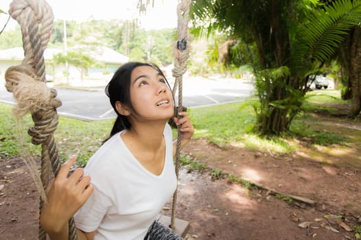 Young asian woman near public board with map, routes and locations