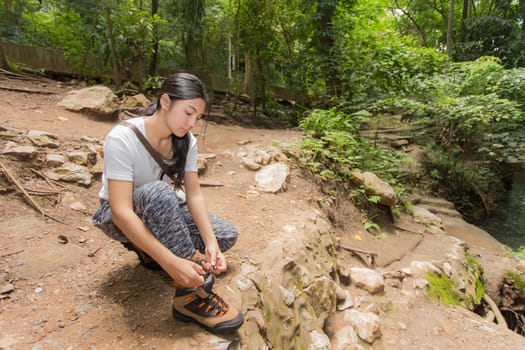 Young asian woman near public board with map, routes and locations