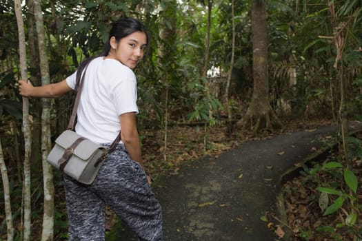 Young asian woman near public board with map, routes and locations