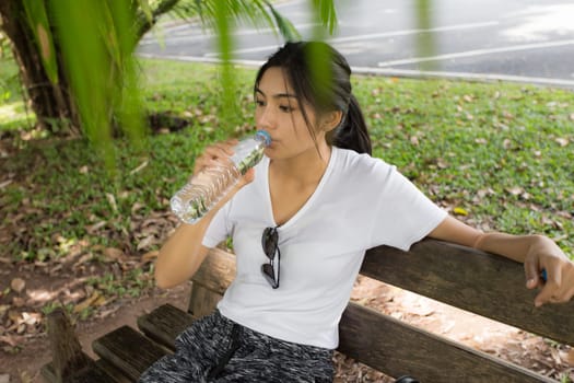 Beautiful smiling young asian woman enjoying yoga, relaxing, feeling alive, breathing fresh air, got freedom from work