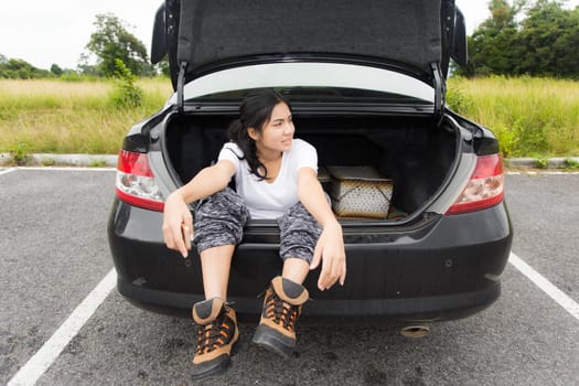 Woman opened the hood Broken car on the side See engines that are damaged or not