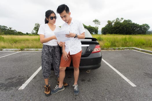 Couple after a car breakdown at the side of the road, woman take a phoen for emergency team
