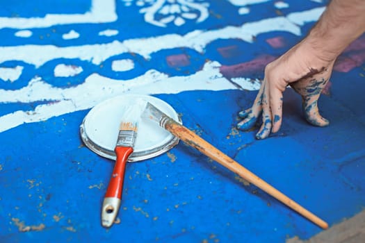 Tools of the street artist and colored pattern on a street of abstract city
