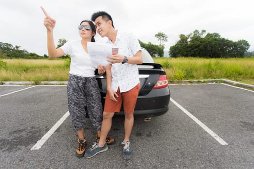 Couple after a car breakdown at the side of the road, woman take a phoen for emergency team