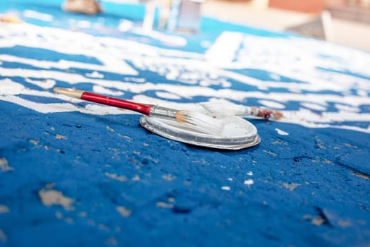 Tools of the street artist and colored pattern on a street of abstract city. Selective focus