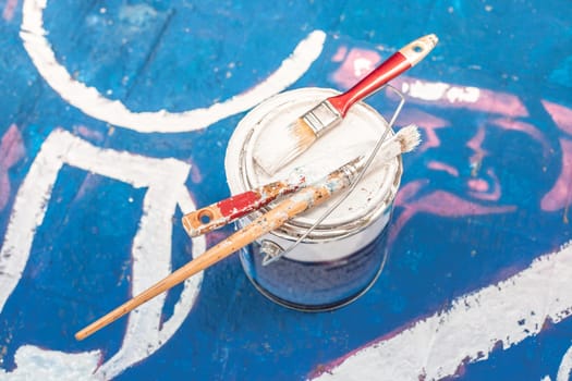 Tools of the street artist and colored pattern on a street of abstract city