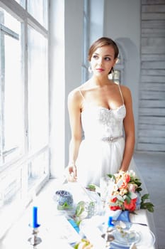 The beautiful bride in wedding dress, white background