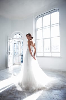 The beautiful bride in wedding dress, white background