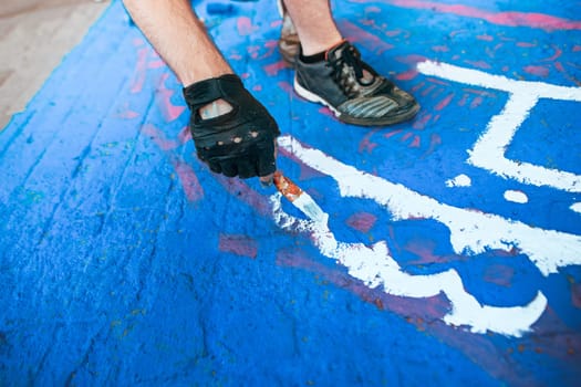 Tools of the street artist and colored pattern on a street of abstract city