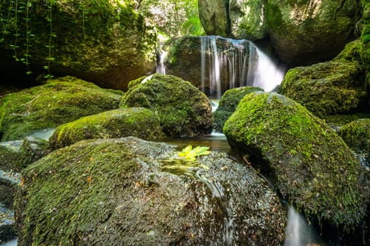 Forest with mountain stream,picturesque landscape with waterfall and moss-covered stones