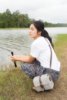 Beautiful smiling young asian woman enjoying yoga, relaxing, feeling alive, breathing fresh air, got freedom from work