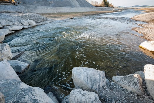 Wide-angle view of the Lech river flowing through the emptied Forggensee in Bavaria.