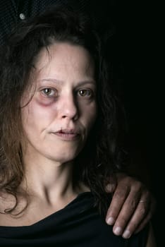 Abused woman with husband, victim of domestic violence
