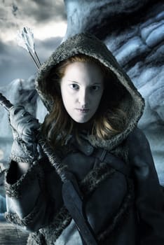 Wild girl archer in the snow with bow