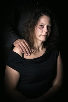 Abused woman with husband, victim of domestic violence