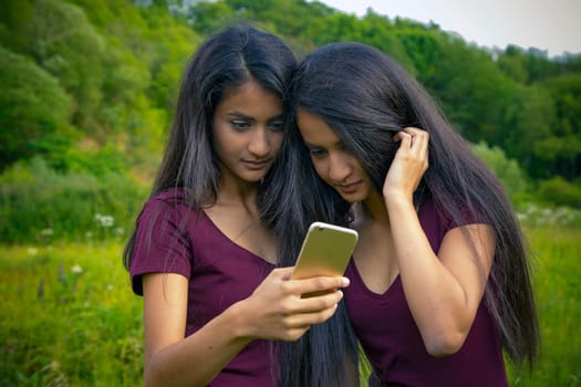 Twins with mobile phone
