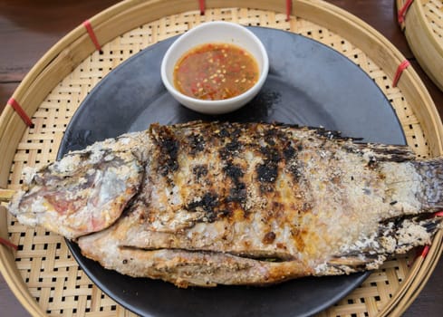 Salt Crusted Grilled Fish and spicy seafood sauce in Thai style